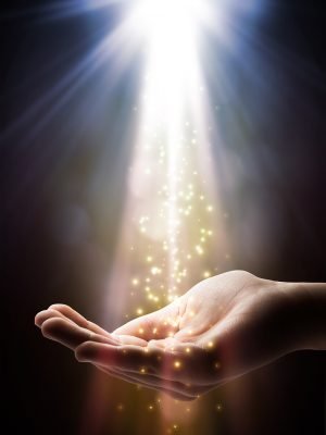 Faith theme. Image of sun rays at top with golden sparkles raining down into outstretched hand.